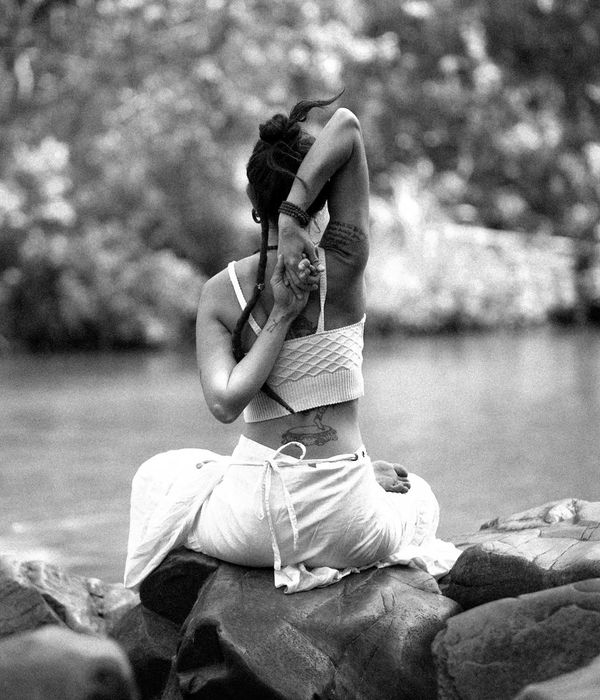 Woman in a calm seated yoga pose, embodying balance and inner peace.